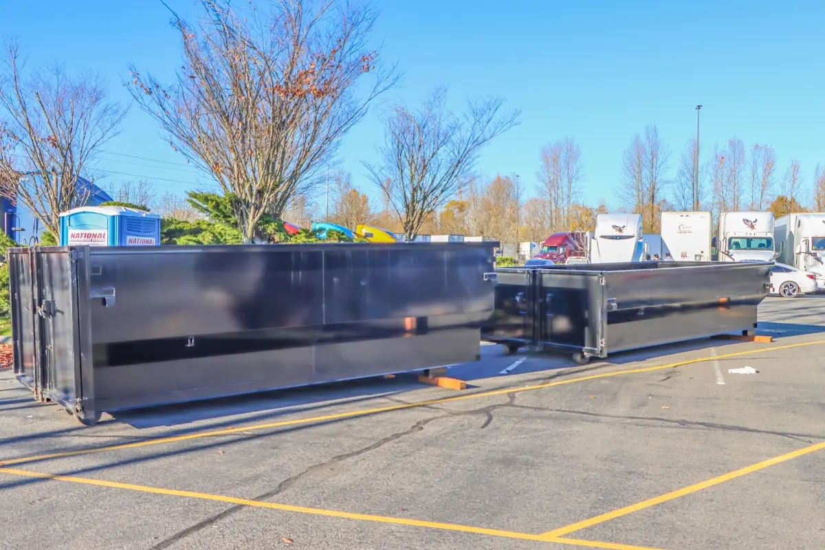 Professional dumpster rental service with roll-off container on residential driveway in Waxhaw